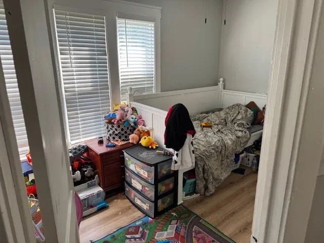 a bedroom with a bed and a window