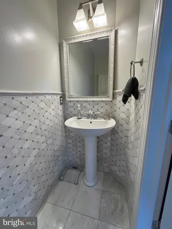 a bathroom with a sink a toilet and mirror