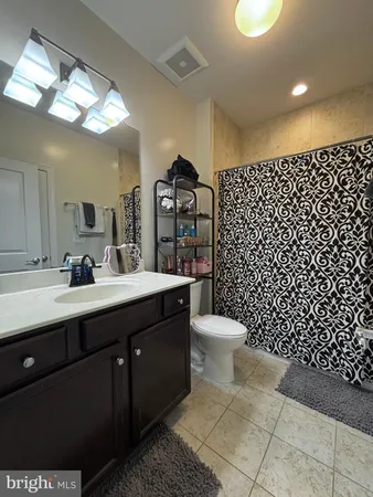 a bathroom with a sink toilet and a mirror