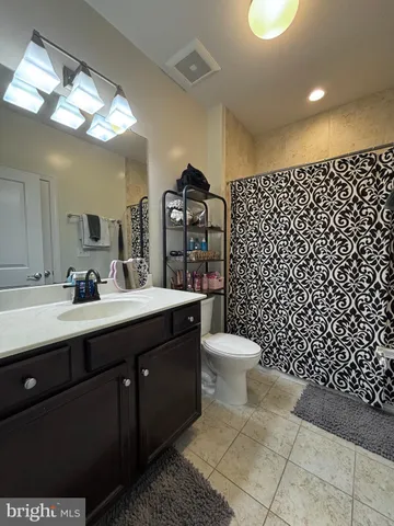 a bathroom with a sink toilet and a mirror