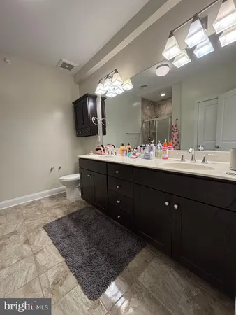 a bathroom with a sink vanity and mirror