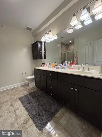 a bathroom with a sink vanity and mirror