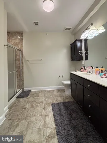 a bathroom with a sink vanity and mirror
