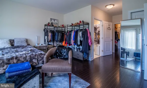 a bedroom with a bed and a view of walk in closet