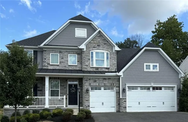 a front view of a house with garage