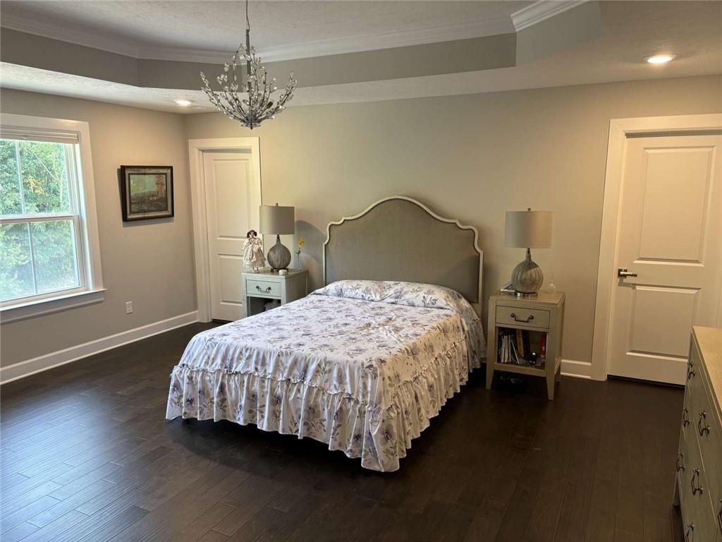 102 Cole Drive McKees Rocks, PA 15136 - Photo 12 of 25 a bed sitting in a spacious bedroom next to a window and a chandelier