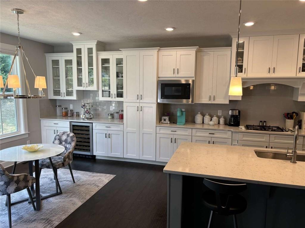 102 Cole Drive McKees Rocks, PA 15136 - Photo 7 of 25 a kitchen with stainless steel appliances kitchen island granite countertop a table chairs sink and cabinets