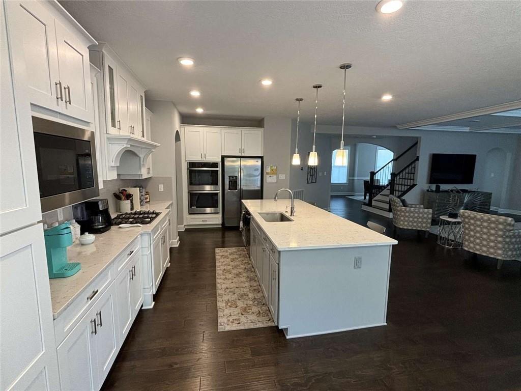 102 Cole Drive McKees Rocks, PA 15136 - Photo 8 of 25 a large white kitchen with lots of counter space dining table and chairs