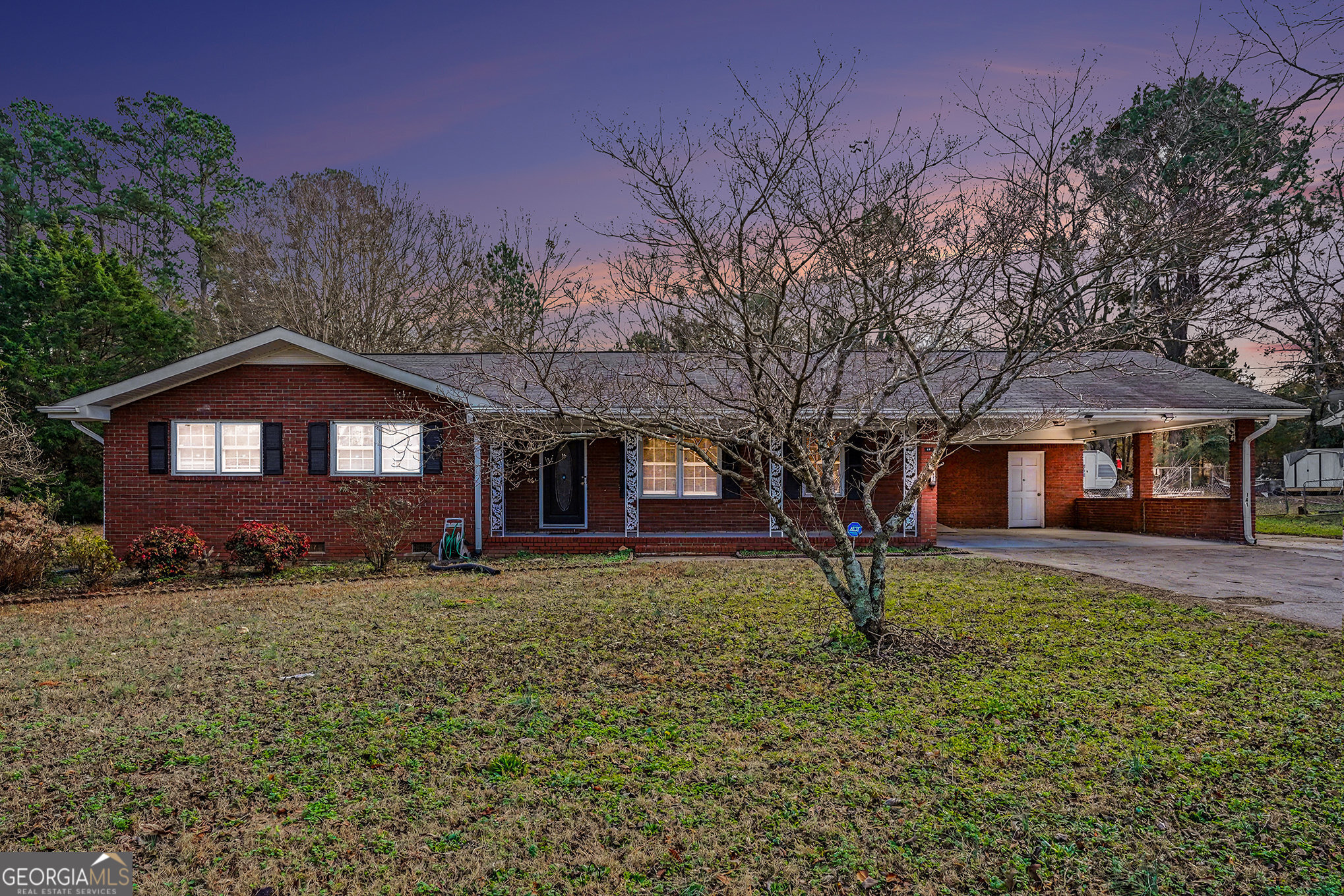 a large tree in front of a house