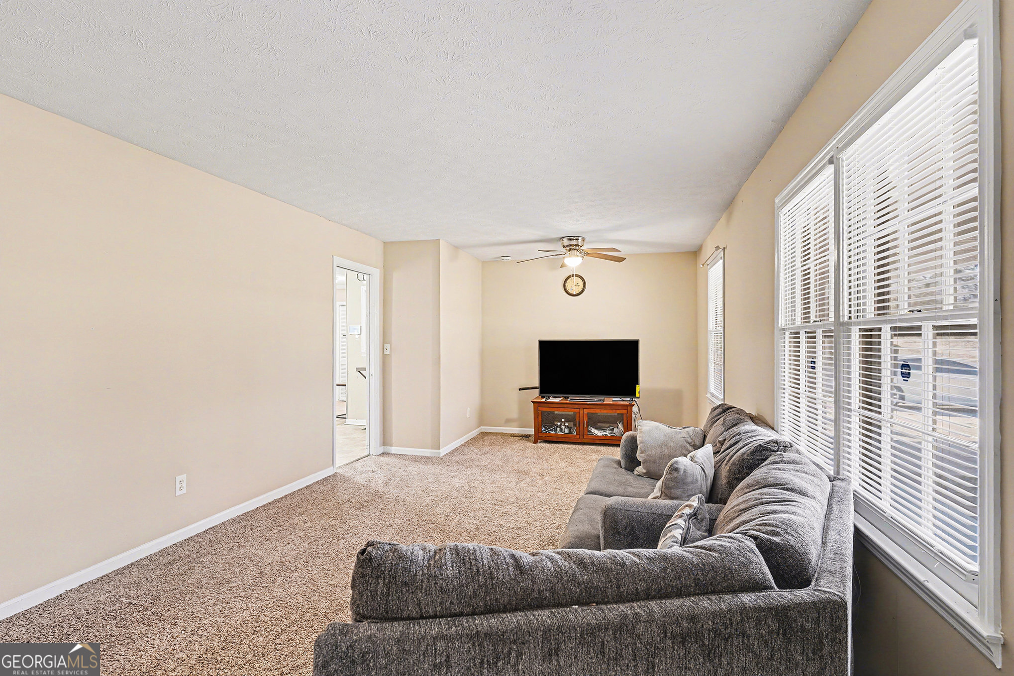 141 Grove Road Locust Grove, GA 30248 - Photo 11 of 27 a living room with furniture and a flat screen tv