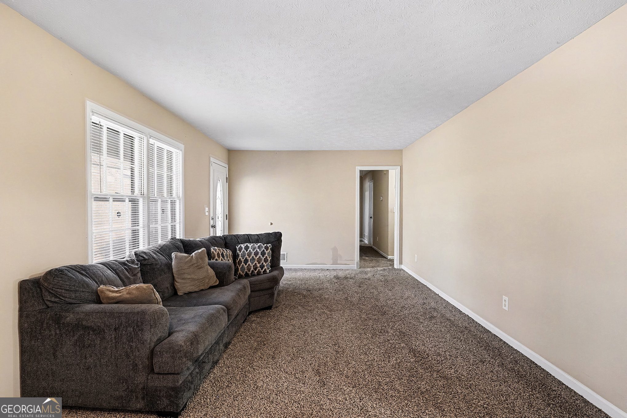 141 Grove Road Locust Grove, GA 30248 - Photo 13 of 27 a living room with furniture and a window