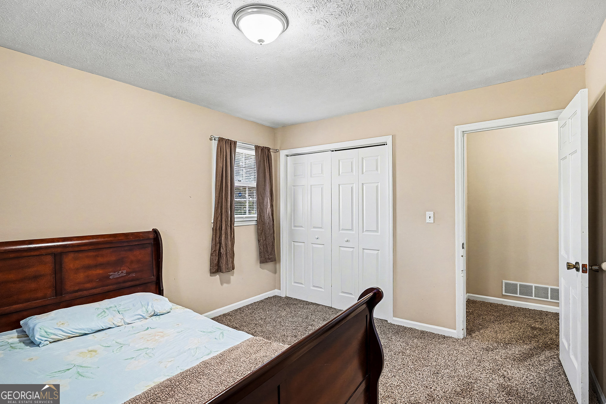 141 Grove Road Locust Grove, GA 30248 - Photo 16 of 27 a bedroom with a bed and a dresser