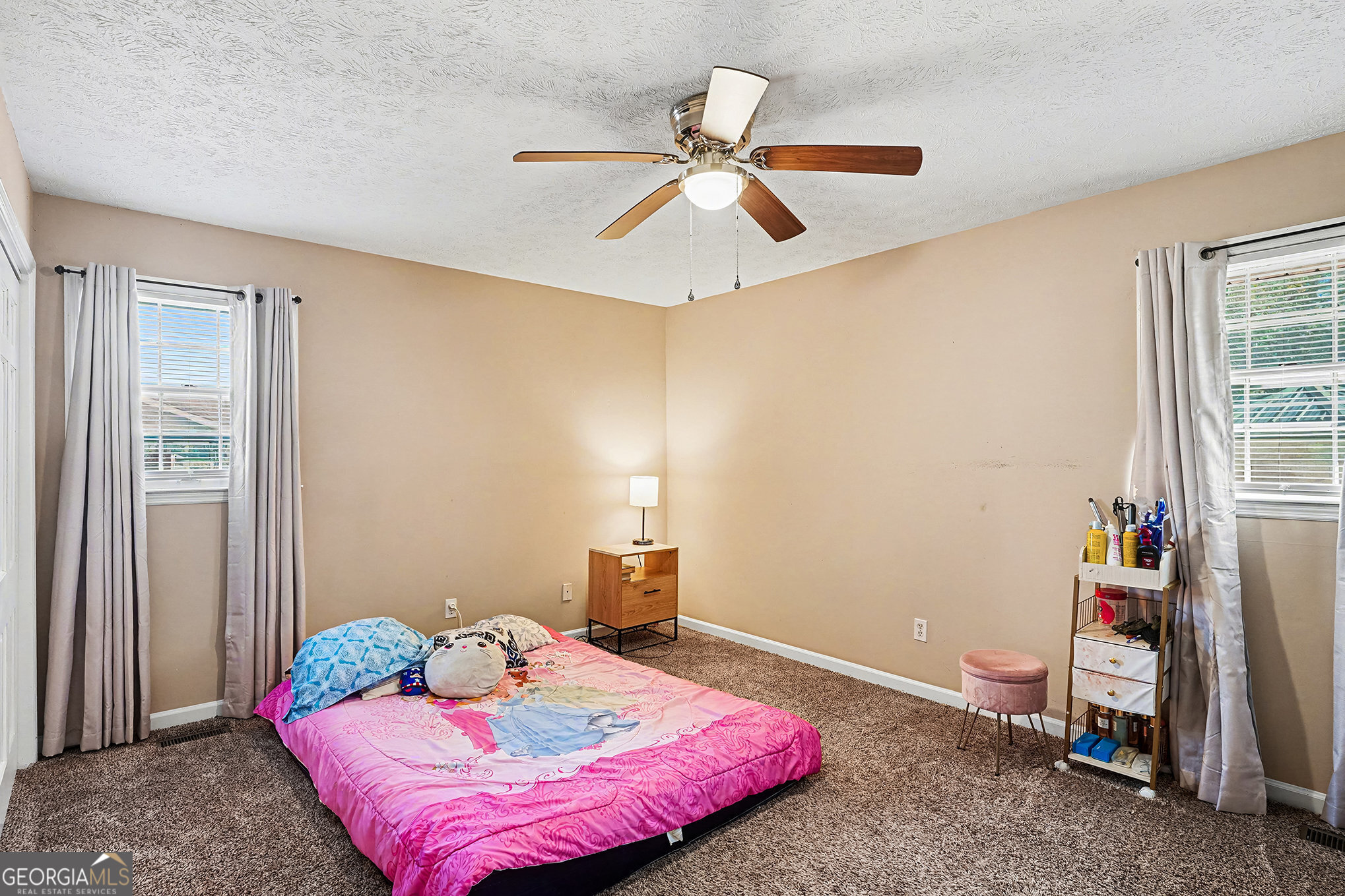 141 Grove Road Locust Grove, GA 30248 - Photo 20 of 27 a bedroom with a bed and a chandelier