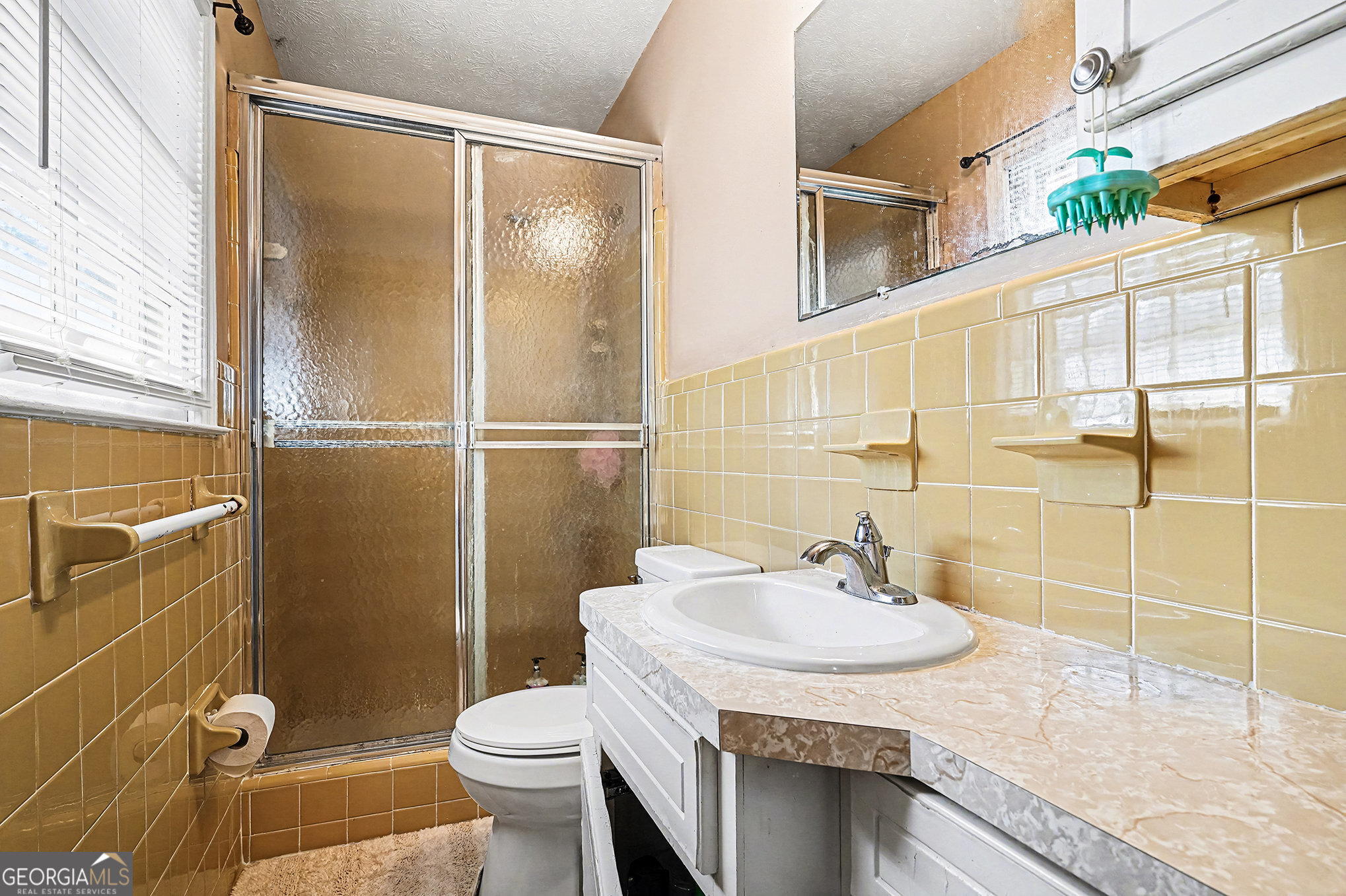 141 Grove Road Locust Grove, GA 30248 - Photo 22 of 27 a bathroom with a sink toilet and shower