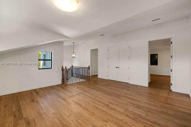 2330 Overbrook Street Coconut Grove, FL 33133 - Photo 65 of 99 a view of an empty room with wooden floor and a window