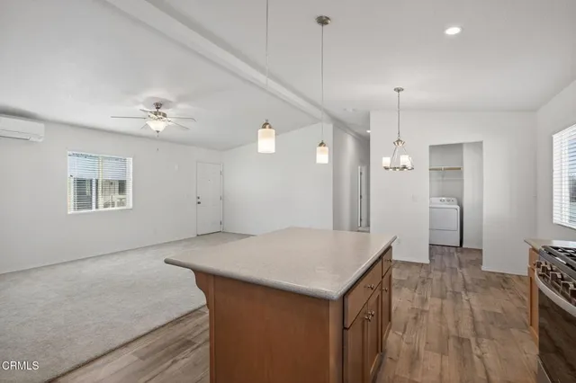 a view of a kitchen counter space and wooden floor