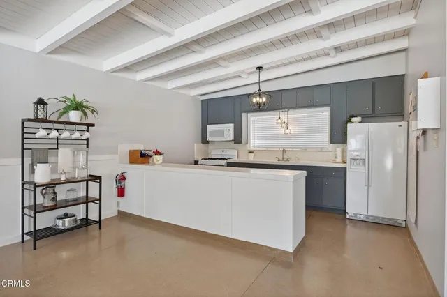 a kitchen with refrigerator and cabinets