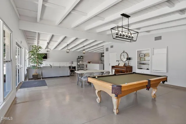 a living room with furniture a chandelier and a table
