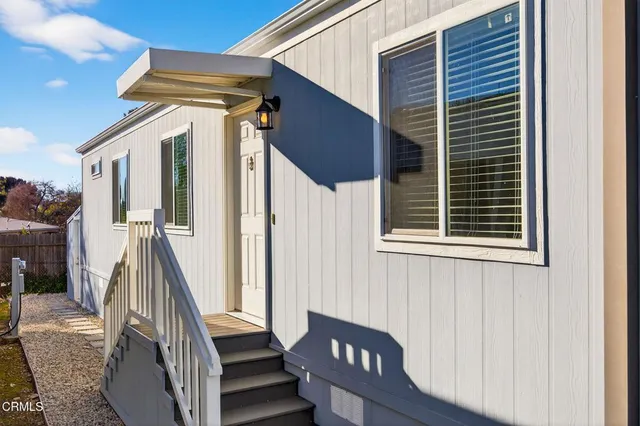 a front view of a house with wooden floor and a glass door