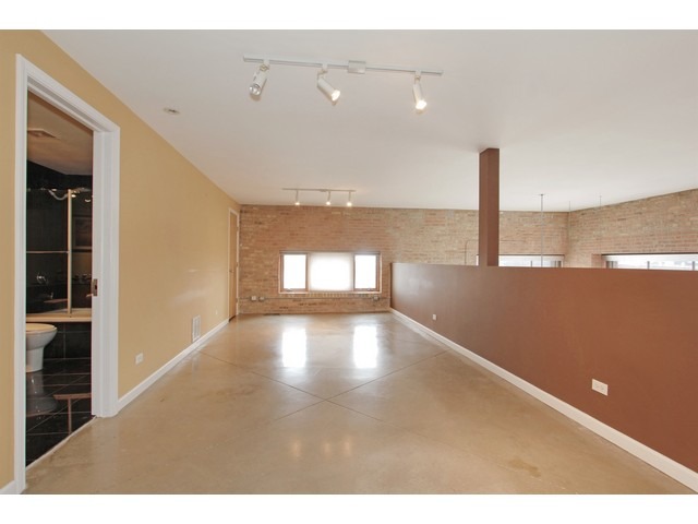 2101 West Rice Street, Unit 301 Chicago, IL 60622 - Photo 6 of 13 a view of an empty room with wooden floor
