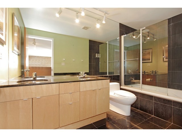 2101 West Rice Street, Unit 301 Chicago, IL 60622 - Photo 8 of 13 a bathroom with a toilet a sink and a large mirror