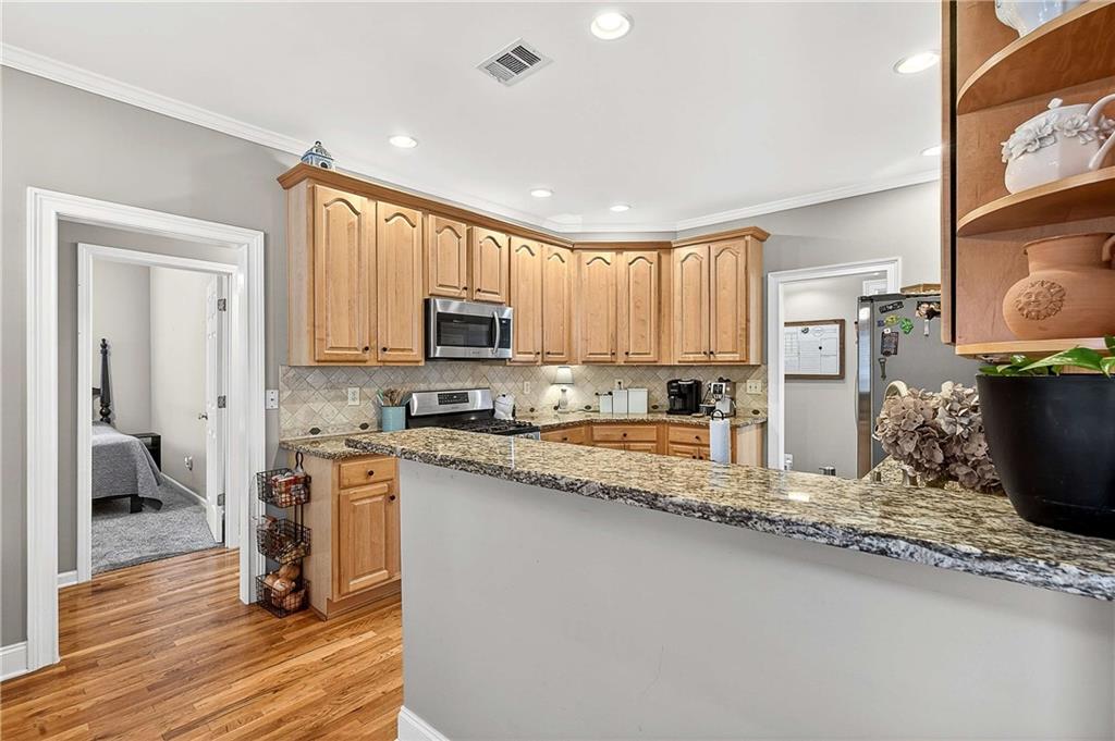 58 Legend Drive Villa Rica, GA 30180 - Photo 11 of 27 a kitchen with granite countertop a stove top oven a sink a counter space and cabinets