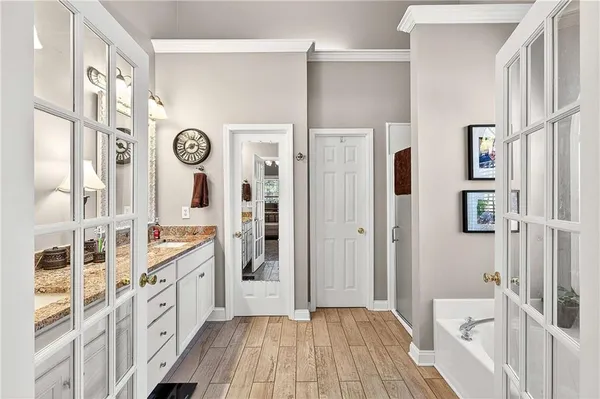 a large bathroom with a double vanity sink and a large mirror