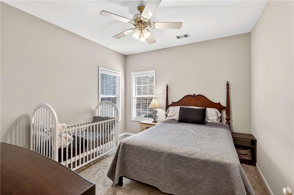 58 Legend Drive Villa Rica, GA 30180 - Photo 17 of 27 a bedroom with a bed and a chandelier