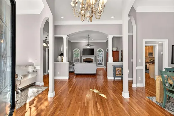 a living room with furniture and a chandelier
