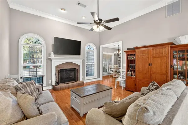 a living room with furniture fireplace and a flat screen tv