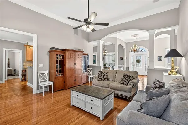 a living room with furniture and wooden floor