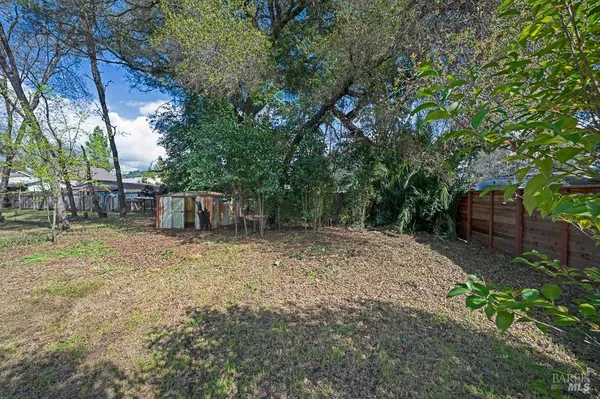 a backyard of a house with a tree