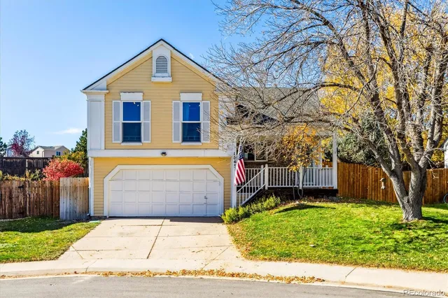 a front view of a house with a yard and a garage
