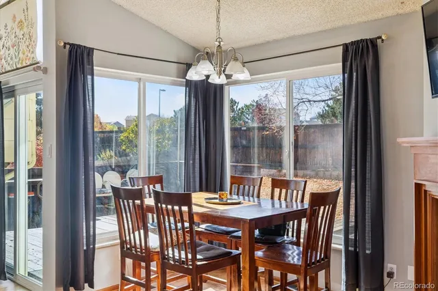 a view of a dining room with furniture large windows and wooden floor