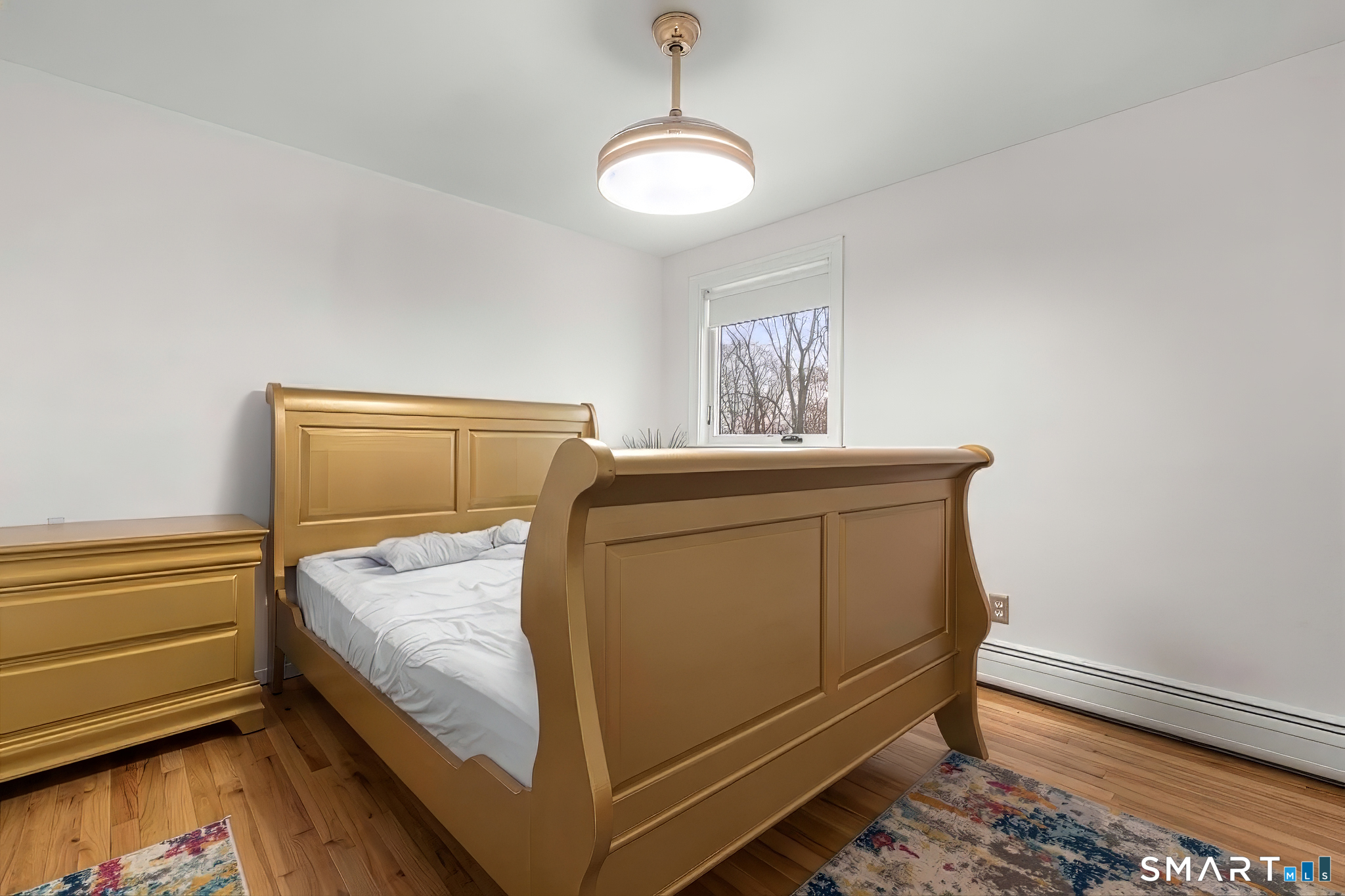 57 Gray Rock Road Trumbull, CT 06611 - Photo 27 of 40 a bedroom with a bed and wooden floor
