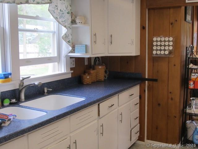 49 Indianola Road East Lyme, CT 06357 - Photo 7 of 7 a kitchen with granite countertop white cabinets and window