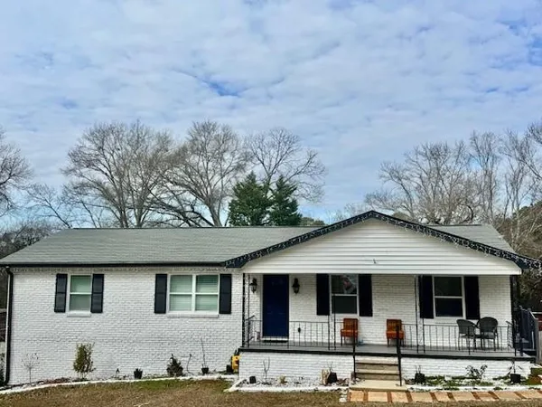 a front view of a house with garden