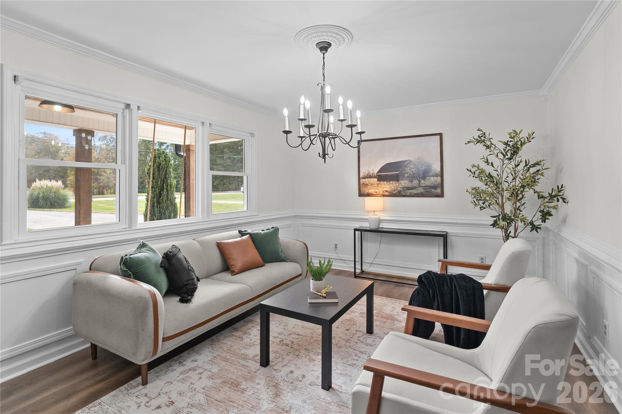 1335 Blacksnake Road Stanley, NC 28164 - Photo 6 of 31 a living room with furniture a chandelier and a fireplace