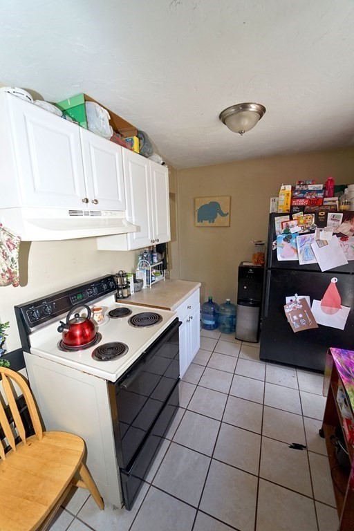 22 Coral Street Fall River, MA 02721 - Photo 17 of 23 a kitchen with a stove a sink cabinetry and a refrigerator