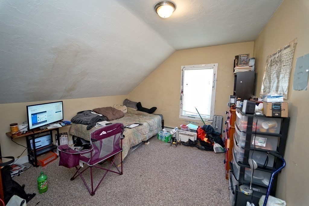 22 Coral Street Fall River, MA 02721 - Photo 19 of 23 a bedroom with furniture and a flat tv screen