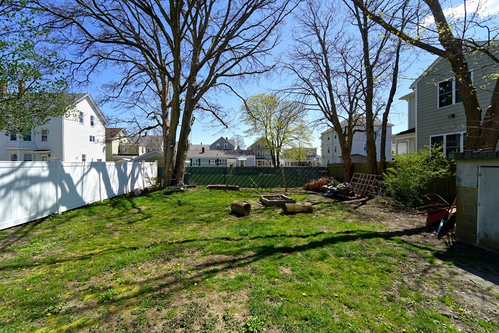 22 Coral Street Fall River, MA 02721 - Photo 23 of 23 a view of backyard with table and chairs and a large tree