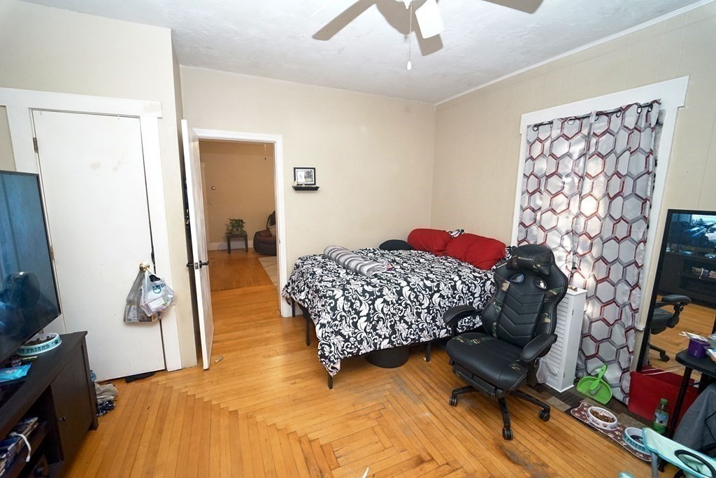 22 Coral Street Fall River, MA 02721 - Photo 8 of 23 a bedroom with a bed and a flat screen tv