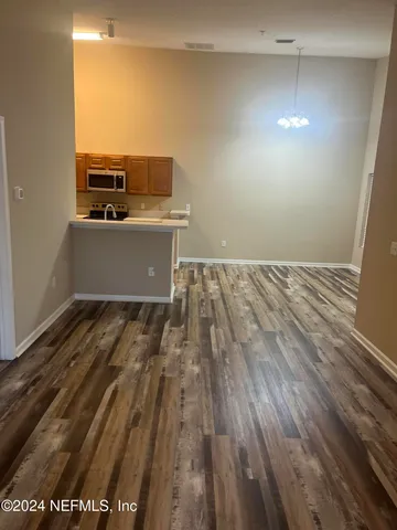a view of a room with wooden floor