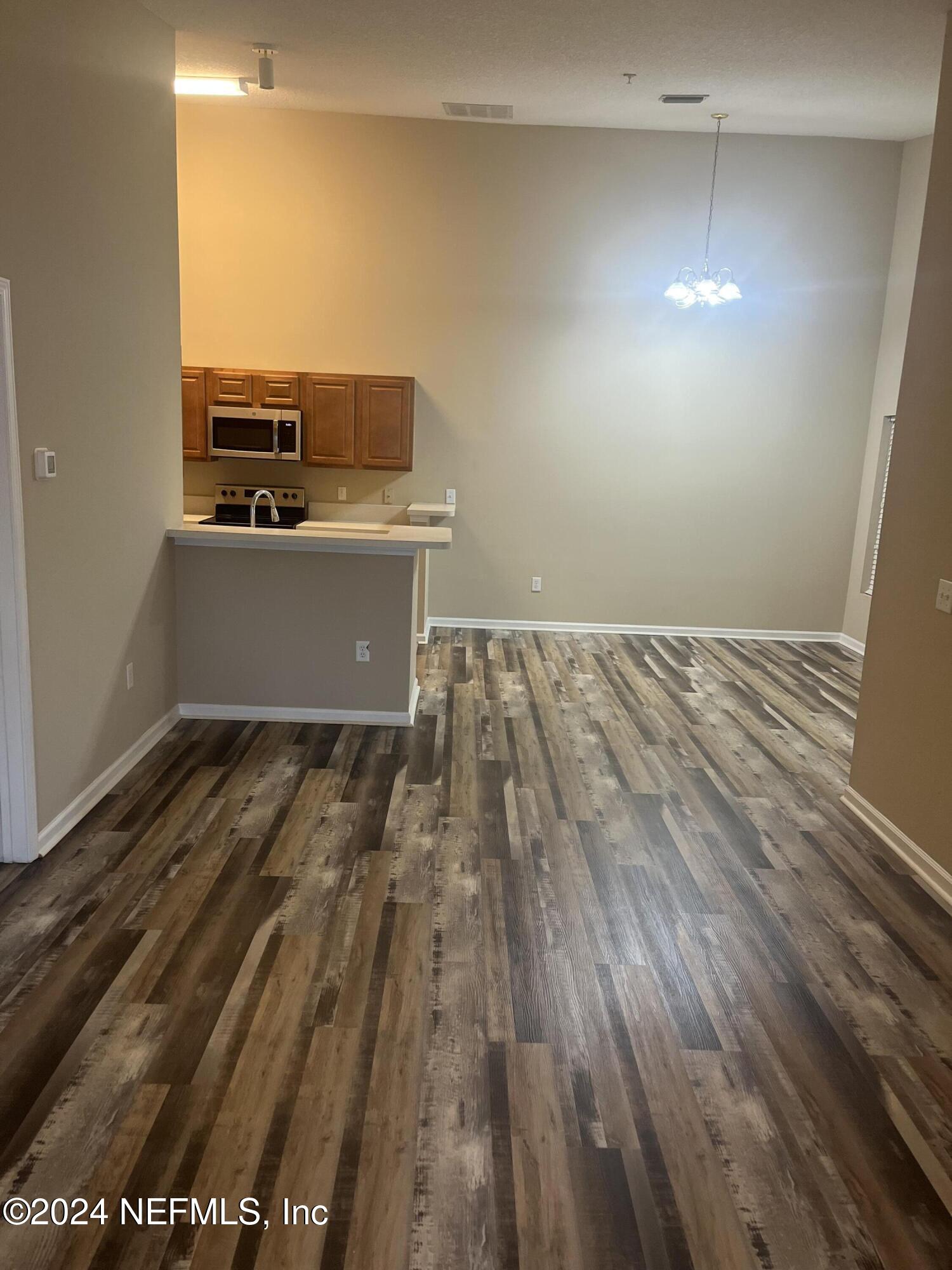 6069 Maggies Circle, Unit 112 Jacksonville, FL 32244 - Photo 4 of 11 a view of a room with wooden floor