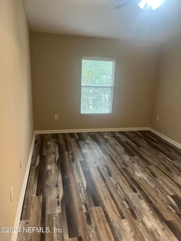 an empty room with wooden floor