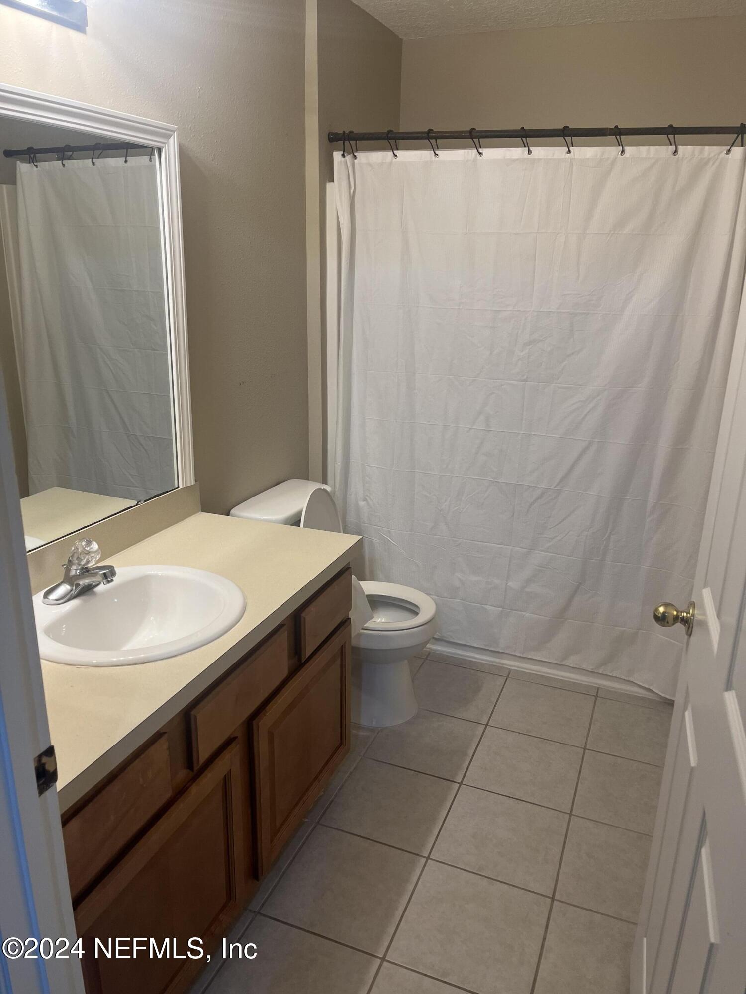 6069 Maggies Circle, Unit 112 Jacksonville, FL 32244 - Photo 7 of 11 a bathroom with a sink and a mirror