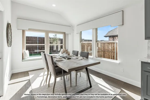 a view of a very nice looking dining room with a table and chairs