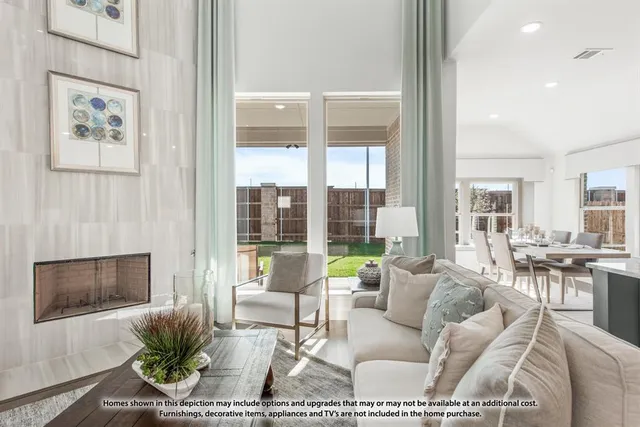 a living room with furniture a flat screen tv and a floor to ceiling window