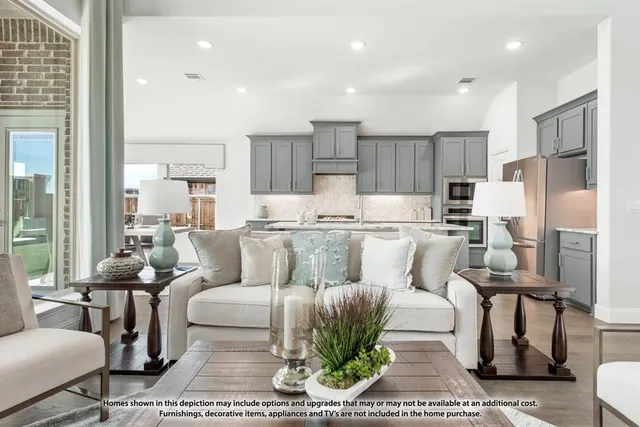 a living room with furniture and a refrigerator
