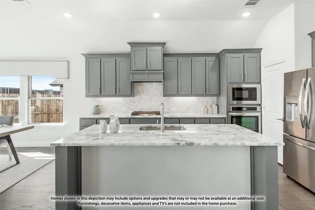 a kitchen with stainless steel appliances granite countertop a sink refrigerator and cabinets